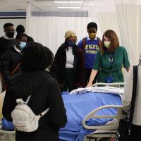 Students around hospital bed